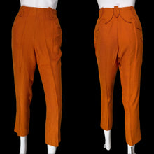 Load image into Gallery viewer, A pair of bright orange cropped trousers shown on a white mannequin from both front and back angles.