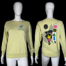 Load image into Gallery viewer, Light yellow sweatshirt with 'Maui and Sons' logo on front and colorful graphic on back, displayed on mannequins.