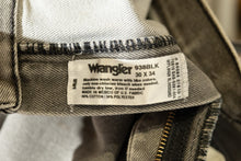 Load image into Gallery viewer, Wrangler label on a piece of clothing with visible text.