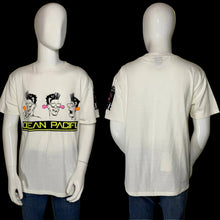 Load image into Gallery viewer, Front and back views of an off-white short-sleeve t-shirt displayed on a white mannequin. The front features a graphic of three cartoon characters and the text 'OCEAN PACIFIC' in yellow on a black bar.