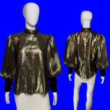 Load image into Gallery viewer, A metallic gold pleated blouse with black long sleeves and a high mock neck, shown on a white mannequin from both front and back views.