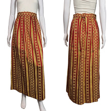Load image into Gallery viewer, Red and gold patterned skirt on a mannequin against a neutral background