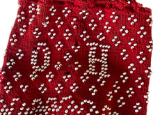 Load image into Gallery viewer, Red fabric with white bead pattern on a clear background