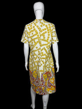 Load image into Gallery viewer, Yellow and white patterned dress on a mannequin