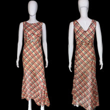 Load image into Gallery viewer, A 1930's sleeveless V-neck midi dress with a diagonal plaid pattern in red and black on a beige base, shown from both front and back on a white mannequin.
