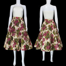 Load image into Gallery viewer, A vintage circle skirt with a pink and green floral print on a cream background, displayed on a white mannequin in a side-by-side front and back view.