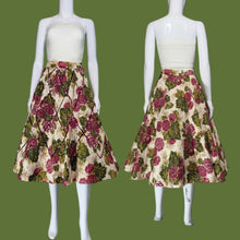 Load image into Gallery viewer, A vintage circle skirt with a pink and green floral print on a cream background, displayed on a white mannequin in a side-by-side front and back view.