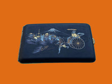 Load image into Gallery viewer, Black wallet with artistic design on a blue background