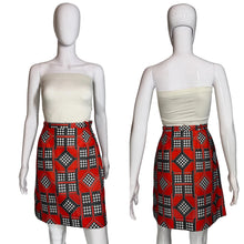 Load image into Gallery viewer, Mannequin wearing a white top and red patterned skort on a plain background.