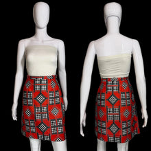 Load image into Gallery viewer, Mannequin wearing a white top and red patterned skort on a plain background.