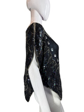 Load image into Gallery viewer, Black stone with engraved patterns on a white stand against a neutral background