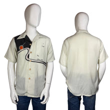 Load image into Gallery viewer, Mannequin wearing a light-colored shirt with a design on a white background
