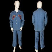 Load image into Gallery viewer, A blue denim two-piece suit displayed on a mannequin, showing both front and back views. The jacket features colorful embroidered patterns on the chest in red, orange, and purple.