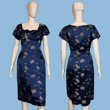 Load image into Gallery viewer, Navy blue dress with floral pattern on a mannequin against a plain background