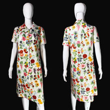 Load image into Gallery viewer, A short-sleeve collared dress with a dense multicolor floral print, shown on a white mannequin from both the front and back views.