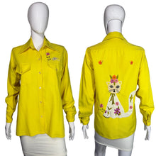 Load image into Gallery viewer, Yellow shirt with cat and flower design on a mannequin