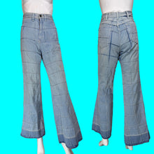 Load image into Gallery viewer, Light blue denim flare pants displayed on a mannequin from the front and back, featuring a grid-like patchwork pattern.