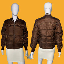 Load image into Gallery viewer, A brown quilted bomber-style jacket shown on a white mannequin from both front and back views.
