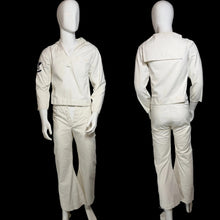 Load image into Gallery viewer, A two-panel photo showing a vgintage sailor unirom displayed on a mannequin from the front and back. The outfit features long sleeves, and matching pants, with a small navy patch on the left sleeve.