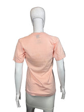 Load image into Gallery viewer, Mannequin wearing a pink t-shirt on a gray background