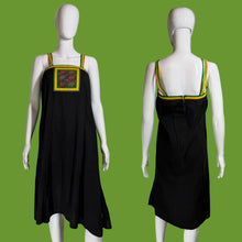 Load image into Gallery viewer, Black dress with colorful trim on a mannequin against a neutral background.