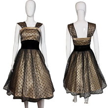 Load image into Gallery viewer, Black and cream polka dot dress on a mannequin with a plain background