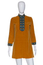 Load image into Gallery viewer, Mustard yellow dress with patterned details on a mannequin against a white background