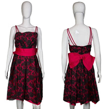 Load image into Gallery viewer, Black floral dress with a red bow on a mannequin against a plain background