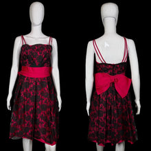 Load image into Gallery viewer, Black floral dress with a red bow on a mannequin against a plain background