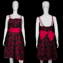 Load image into Gallery viewer, Black floral dress with a red bow on a mannequin against a plain background