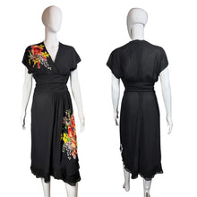 Load image into Gallery viewer, Black dress with floral applique on a mannequin against a neutral background