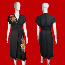 Load image into Gallery viewer, Black dress with floral applique on a mannequin against a neutral background