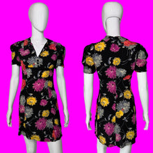 Load image into Gallery viewer, A short-sleeve black dress with a colorful floral print, displayed on a white mannequin from the front and back.
