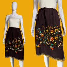 Load image into Gallery viewer, Brown skirt with colorful floral embroidery on a mannequin against a white background.
