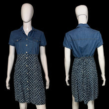 Load image into Gallery viewer, A denim dress displayed on a white mannequin, showing both front and back views. The top is a solid medium blue denim short-sleeve button-up shirt, and the skirt is a dark blue and white floral patterned button-down dress.