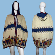 Load image into Gallery viewer, Mannequin wearing a patterned cape with a cityscape design on a plain background