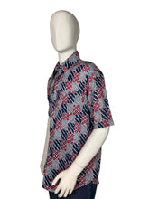 Load image into Gallery viewer, Mannequin wearing a patterned shirt on a plain background