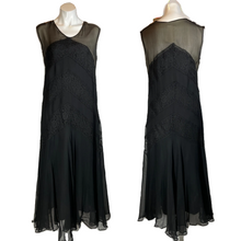 Load image into Gallery viewer, A vintage 1920's black chiffon and lace flapper dress with a straight silhouette, chevron stripes, and an illusion bodice, displayed on a mannequin.