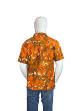 Load image into Gallery viewer, Mannequin wearing an orange floral shirt and blue jeans on a white background