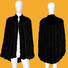 Load image into Gallery viewer, A black textured cape jacket with a scalloped ruffled edge and high collar, shown from both front and back views on a white mannequin against a plain white wall.