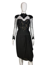 Load image into Gallery viewer, Black dress with sheer sleeves and embellishments on a mannequin against a neutral background