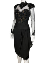 Load image into Gallery viewer, Black dress with sheer sleeves and embellishments on a mannequin against a neutral background