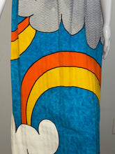 Load image into Gallery viewer, Colorful fabric with orange, yellow, and blue design on a gray background