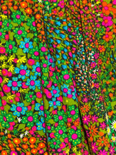 Load image into Gallery viewer, Colorful floral dress on a mannequin against a plain wall.