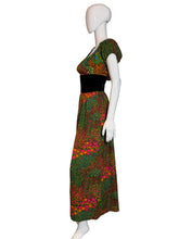 Load image into Gallery viewer, Mannequin wearing a colorful patterned dress on a white wall.