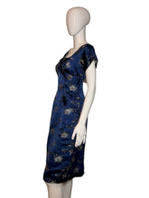 Load image into Gallery viewer, Mannequin wearing a blue dress with floral patterns on a plain background