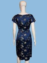 Load image into Gallery viewer, Navy blue dress with white floral pattern on a mannequin against a plain background
