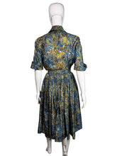 Load image into Gallery viewer, Blue and green floral dress on a mannequin against a white background