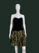 Load image into Gallery viewer, Black strapless dress with a gold tiered skirt on a mannequin against a plain background
