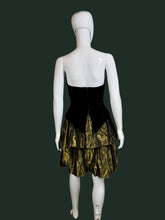 Load image into Gallery viewer, Mannequin wearing a black and gold dress against a plain wall.